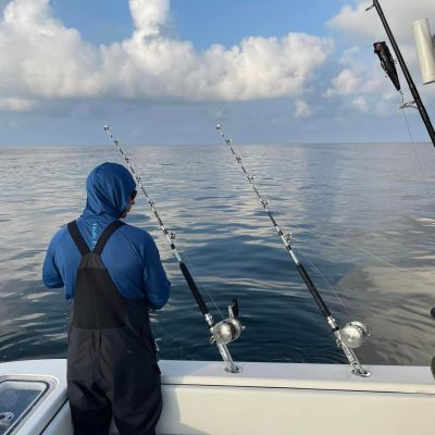 a man standing next to a body of water