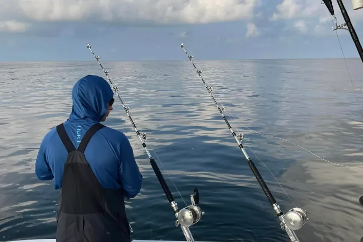 a man standing next to a body of water