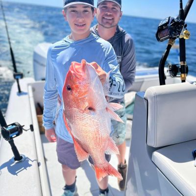 a person holding a fish on a boat