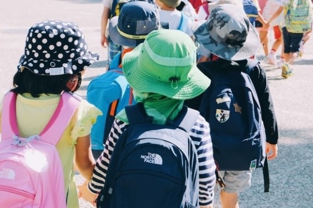 a group of kids wearing school bags going on a field trip