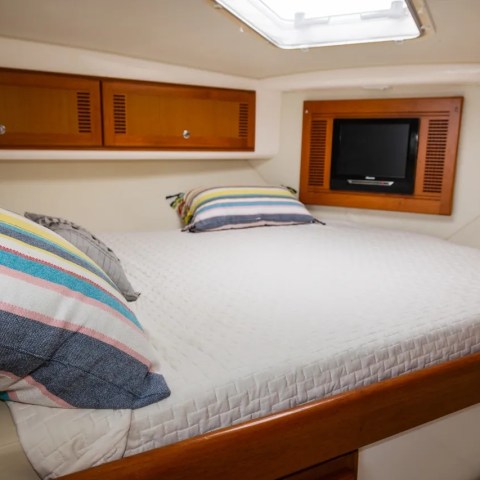 a bedroom with a bed and desk in a room